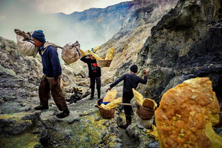 Ijen Sulfur Miner taking sulfur from crater
